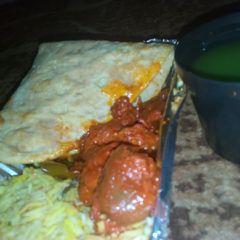 A picture of Basmati rice with tamisa bread and meat souce.