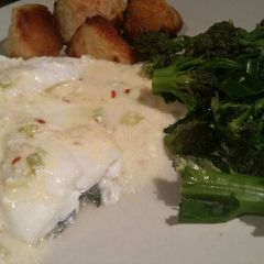 A picture of White fish in a hot smoked-cheese sauce.