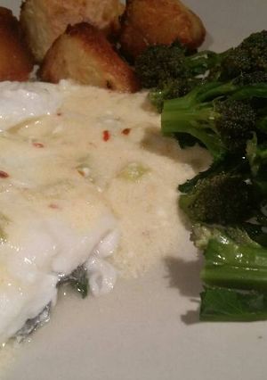 A picture of White fish in a hot smoked-cheese sauce.