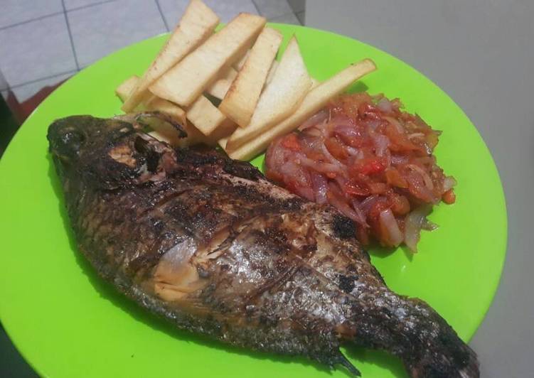 Roasted fish with yam chips and onion sauce