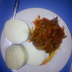 A picture of Garden egg stew and boiled yam.