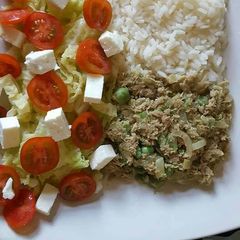 A picture of Lemon scented rice and tuna, with salad.