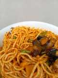 Fried Baby Snails On Mixed Veggies Jollof Pasta
