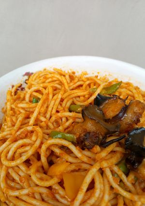 A picture of Fried Baby Snails On Mixed Veggies Jollof Pasta.