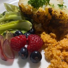 A picture of Slovenian spiced cauliflower with couscous and pickled cauliflower leaves.