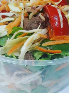 A picture of Grilled Chicken breast and pasta salad.