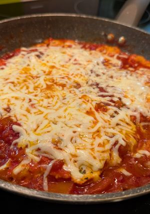 A picture of Italian-Style Shakshuka with Bell Peppers and Cheese.
