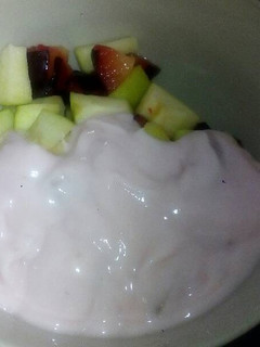 A picture of Fruit salad and yoghurt.