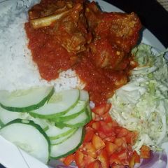 A picture of Rice and stew with cabbage salad.