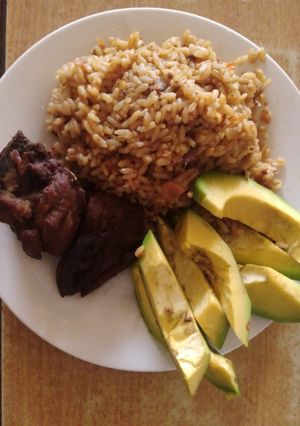 A picture of Jollof rice chi chicken with apple.