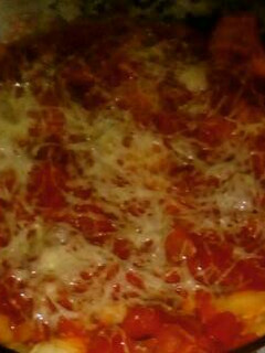 Una foto de Canelones de espinaca, ricota y choclo con salsa de tomate