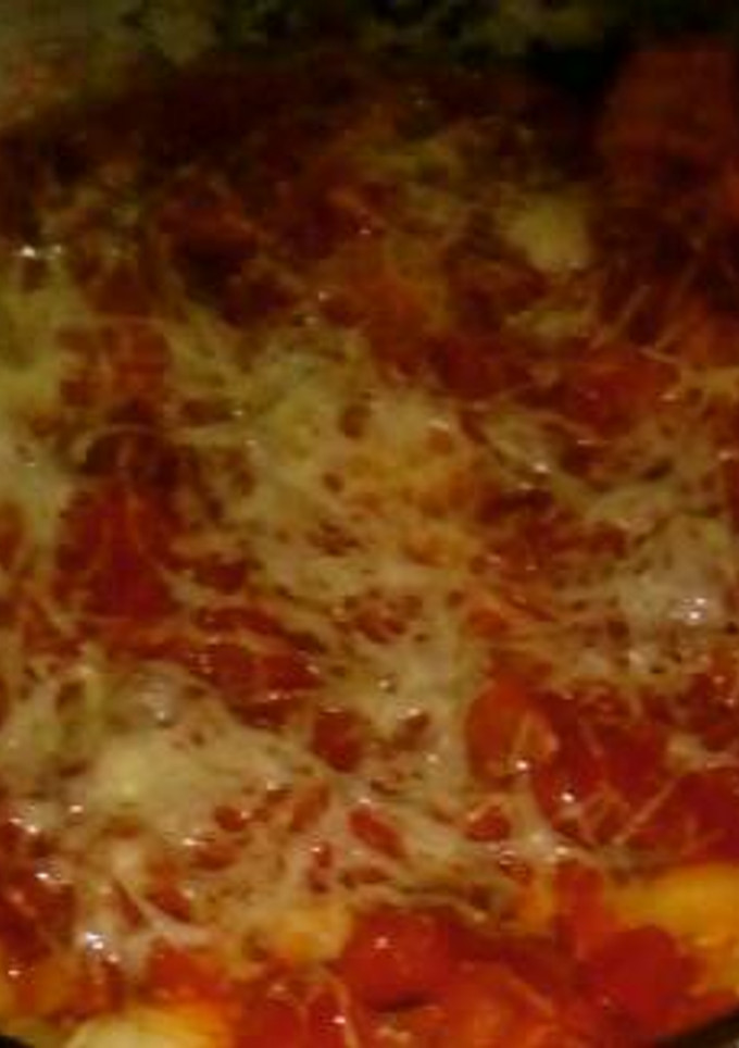Una foto de Canelones de espinaca, ricota y choclo con salsa de tomate