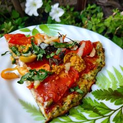 A picture of Pizza (chicken pizza with spinach).