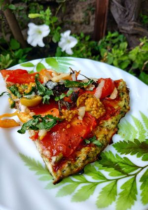 A picture of Pizza (chicken pizza with spinach).