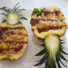 A picture of Fried Pineapple Rice on a Pineapple Boat.