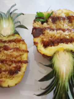 A picture of Fried Pineapple Rice on a Pineapple Boat.