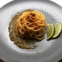 A picture of Spaghettini with grey mullet bottarga, lime and walnuts on truffle pesto.