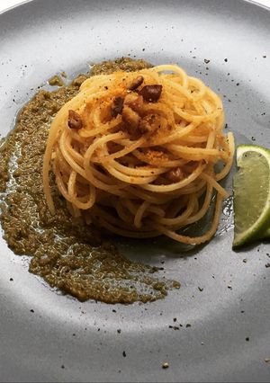 A picture of Spaghettini with grey mullet bottarga, lime and walnuts on truffle pesto.