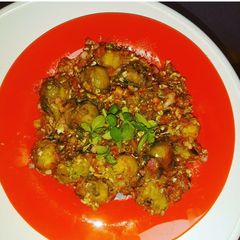 A picture of Brussels Sprouts in Veggie Sauce and Egg, with Basil.