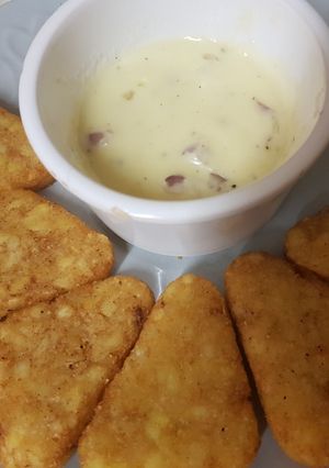 A picture of Hashbrowns and two Cheese and onion dip.