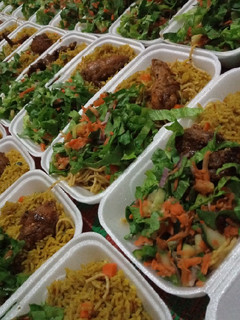 A picture of Party jollof rice with hot n spiced chicken and season salad.