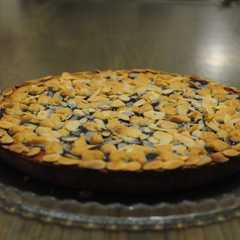 A picture of Jam Tart with Red Fruit Preserves and Sliced Almonds.