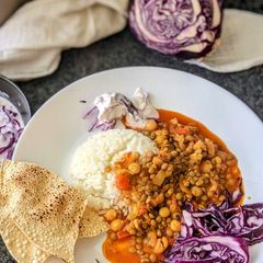 A picture of Mixed lentil Curry with Purple cabbage salad.
