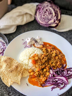 A picture of Mixed lentil Curry with Purple cabbage salad.