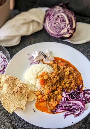 A picture of Mixed lentil Curry with Purple cabbage salad.