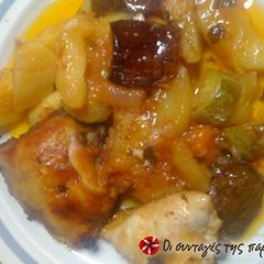 A picture of Chicken in wine with eggplants in the oven.
