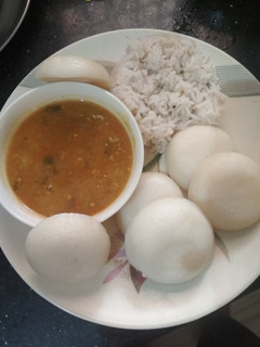 A picture of Sambar with idli or rice.