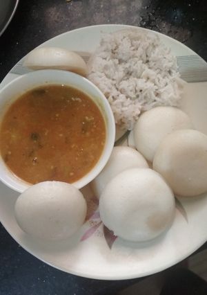 A picture of Sambar with idli or rice.