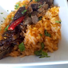 A picture of Mexican rice with Mexican beef.