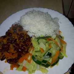 A picture of White rice,black beans in grated carrots n mixed vegetables.