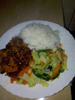 A picture of White rice,black beans in grated carrots n mixed vegetables.