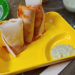 A picture of Schezwan Paneer Dosa rolls.