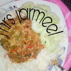 A picture of White rice with vegetable sauce.
