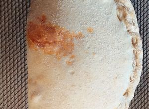 Una foto de Calzone con salsa de tomate