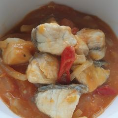 A picture of Barramundi in tomatoes sauce.