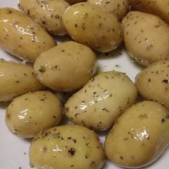 New potatoes with a garlic and herb butter A picture of New potatoes with a garlic and herb butter.