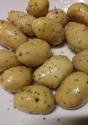 A picture of New potatoes with a garlic and herb butter.
