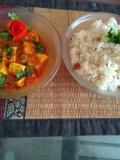 A picture of Paneer korma with jeera rice.