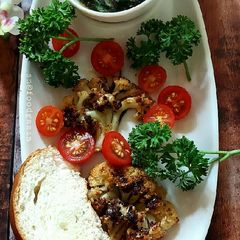 A picture of Grilled Cauliflower Steaks with Chimichuri Sauce.