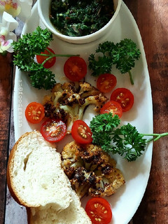 A picture of Grilled Cauliflower Steaks with Chimichuri Sauce.