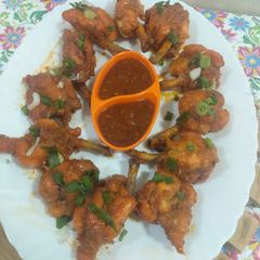 A picture of Lollipops with schezwan sauce.