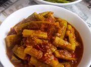 A picture of red chillies and onions