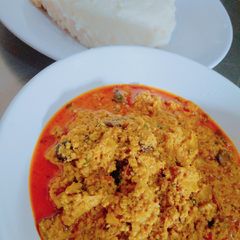 A picture of Ufia Anan (sesame soup) with maize and cassava pudding.