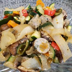 A picture of Onion and pepper stir fry with chicken sausage.