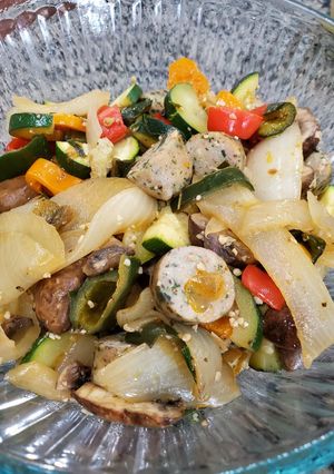 A picture of Onion and pepper stir fry with chicken sausage.