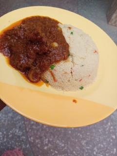 A picture of Garnished couscous with beef stew.